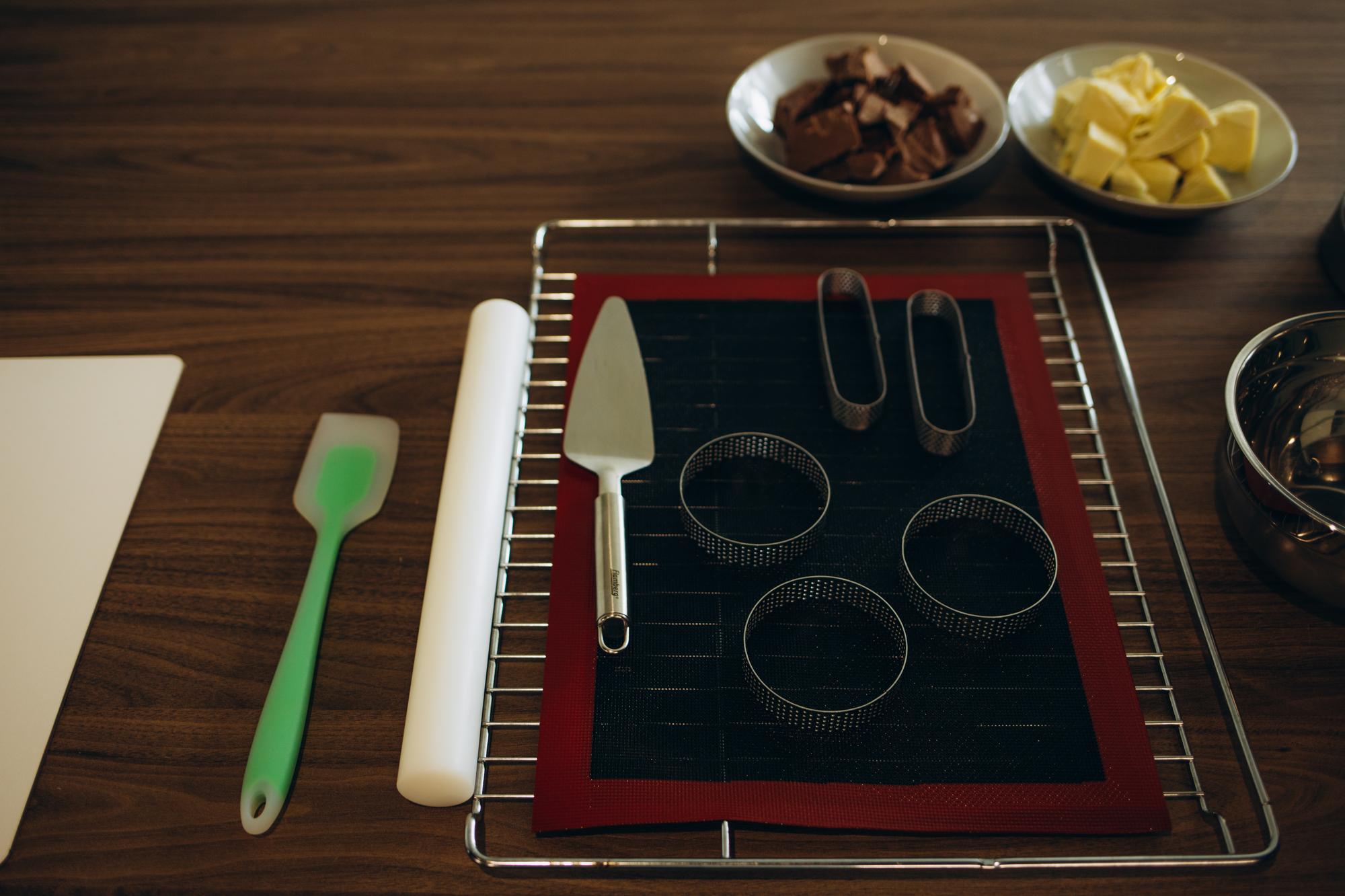 Close-up of mise-en-place trays with labeled tools